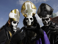 Three people dress as the lead singer of the band Ghost during the Zombie March in Mexico City, Mexico, on October 19, 2024, which starts fr...