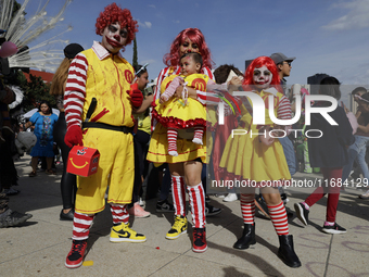 Three people dress as Ronald McDonald during the Zombie March in Mexico City, Mexico, on October 19, 2024, which starts from the Monument to...