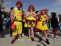 Three people dress as Ronald McDonald during the Zombie March in Mexico City, Mexico, on October 19, 2024, which starts from the Monument to...