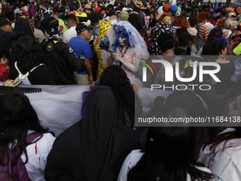 Dozens of people dressed in costume participate in the Zombie March in Mexico City, Mexico, on October 19, 2024, which starts from the Monum...