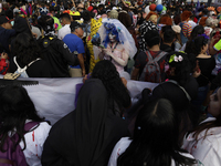 Dozens of people dressed in costume participate in the Zombie March in Mexico City, Mexico, on October 19, 2024, which starts from the Monum...