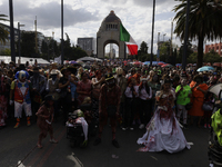 Dozens of people dressed in costume participate in the Zombie March in Mexico City, Mexico, on October 19, 2024, which starts from the Monum...