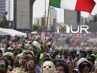 A person dresses as the horror movie character Jason during the Zombie March in Mexico City, Mexico, on October 19, 2024, which starts from...