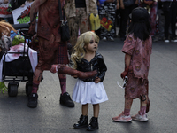 Dozens of people dressed in costume participate in the Zombie March in Mexico City, Mexico, on October 19, 2024, which starts from the Monum...