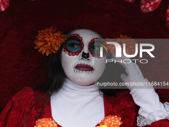 A woman dresses as a catrina during the Zombie March in Mexico City, Mexico, on October 19, 2024, which starts from the Monument to the Revo...