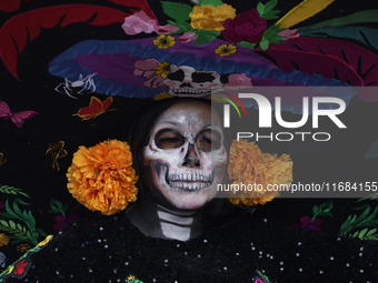 A woman dresses as a catrina during the Zombie March in Mexico City, Mexico, on October 19, 2024, which starts from the Monument to the Revo...