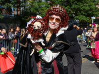 A woman and her dog wear matching costumes with wigs for the 34th Annual Tompkins Square Halloween Dog Parade in Tompkins Square Park in New...