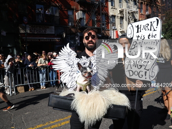 Owners and their dog dress as angels for the 34th Annual Tompkins Square Halloween Dog Parade in Tompkins Square Park in New York City, USA,...