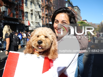 An owner carries her dog as they walk during the 34th Annual Tompkins Square Halloween Dog Parade in Tompkins Square Park in New York City,...