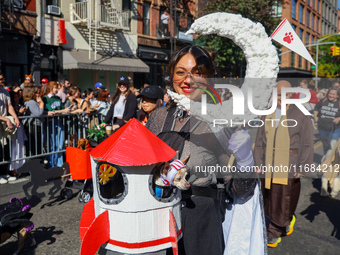 A woman and her dog dress for space travel for the 34th Annual Tompkins Square Halloween Dog Parade in Tompkins Square Park in New York City...