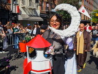 A woman and her dog dress for space travel for the 34th Annual Tompkins Square Halloween Dog Parade in Tompkins Square Park in New York City...