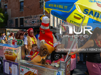 A family and pets dress as a hot dog stand for the 34th Annual Tompkins Square Halloween Dog Parade in Tompkins Square Park in New York City...