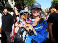 A woman and her dog dress for space travel for the 34th Annual Tompkins Square Halloween Dog Parade in Tompkins Square Park in New York City...