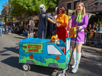 Scooby Doo themed costumes with a Mystery Machine cart for dogs and owners appear at the 34th Annual Tompkins Square Halloween Dog Parade in...