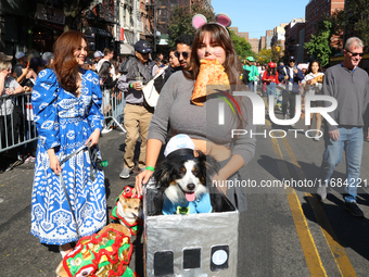 A dog and owner are the MTA Subway and a pizza rat for the 34th Annual Tompkins Square Halloween Dog Parade in Tompkins Square Park in New Y...