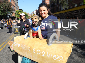 A dog and owner dress as Olympic medalists for the 34th Annual Tompkins Square Halloween Dog Parade in Tompkins Square Park in New York City...