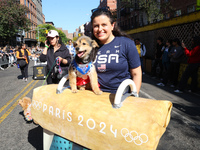 A dog and owner dress as Olympic medalists for the 34th Annual Tompkins Square Halloween Dog Parade in Tompkins Square Park in New York City...