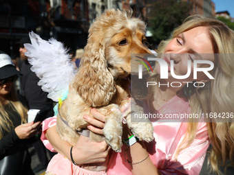 A dog and her owner dress as angels for the 34th Annual Tompkins Square Halloween Dog Parade in Tompkins Square Park in New York City, USA,...