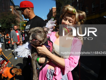 A dog and her owner dress as angels for the 34th Annual Tompkins Square Halloween Dog Parade in Tompkins Square Park in New York City, USA,...