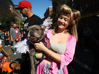 A dog and her owner dress as angels for the 34th Annual Tompkins Square Halloween Dog Parade in Tompkins Square Park in New York City, USA,...