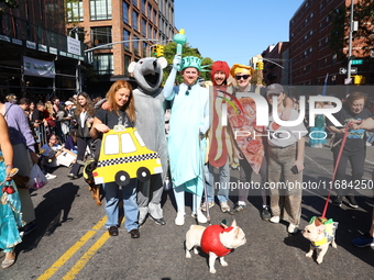 A group of friends and a dog represent NYC icons for the 34th Annual Tompkins Square Halloween Dog Parade in Tompkins Square Park in New Yor...