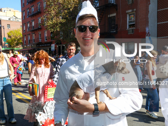 A dog and his owner dress as chefs for the 34th Annual Tompkins Square Halloween Dog Parade in Tompkins Square Park in New York City, USA, o...