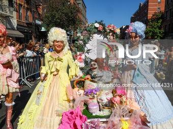 A dog and its owners dress in Baroque style with big gowns, big hair, and corsets for the 34th Annual Tompkins Square Halloween Dog Parade i...