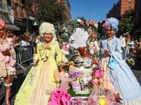 A dog and its owners dress in Baroque style with big gowns, big hair, and corsets for the 34th Annual Tompkins Square Halloween Dog Parade i...