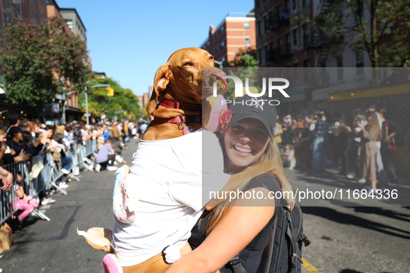 A dog is carried by its owner for the 34th Annual Tompkins Square Halloween Dog Parade in Tompkins Square Park in New York City, USA, on Oct...