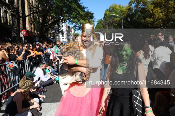 A dog and its owners pay tribute to the Wizard of Oz as they march during the 34th Annual Tompkins Square Halloween Dog Parade in Tompkins S...