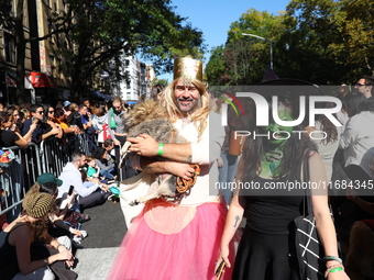 A dog and its owners pay tribute to the Wizard of Oz as they march during the 34th Annual Tompkins Square Halloween Dog Parade in Tompkins S...