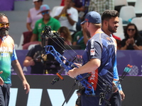 Prathamesh Balchandra Fuge of India and Mike Schloesser of the Netherlands compete during the men's compound bronze medal match on the secon...