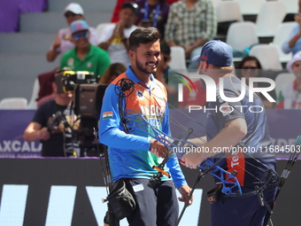 Prathamesh Balchandra Fuge of India and Mike Schloesser of the Netherlands compete during the men's compound bronze medal match on the secon...