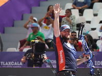 Mike Schloesser of the Netherlands competes against Prathamesh Balchandra Fuge of India (not in picture) during the men's compound bronze me...