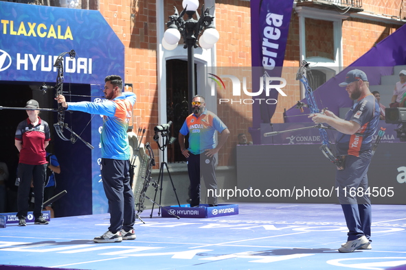 Prathamesh Balchandra Fuge of India and Mike Schloesser of the Netherlands compete during the men's compound bronze medal match on the secon...