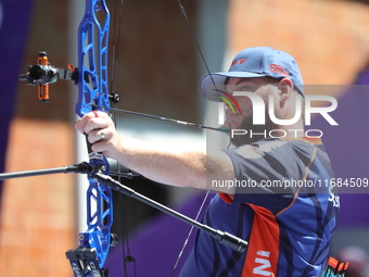 Mike Schloesser of the Netherlands competes against Prathamesh Balchandra Fuge of India (not in picture) during the men's compound bronze me...