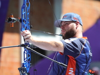 Mike Schloesser of the Netherlands competes against Prathamesh Balchandra Fuge of India (not in picture) during the men's compound bronze me...