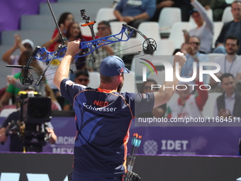 Mike Schloesser of the Netherlands competes against Prathamesh Balchandra Fuge of India (not in picture) during the men's compound bronze me...