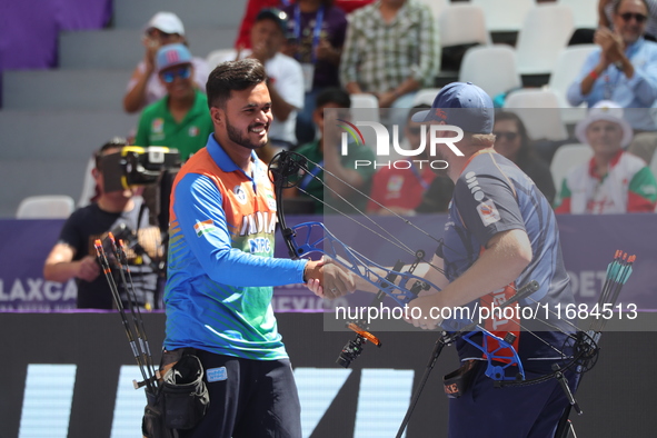 Prathamesh Balchandra Fuge of India and Mike Schloesser of the Netherlands compete during the men's compound bronze medal match on the secon...