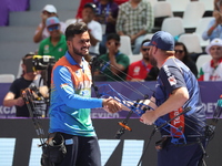 Prathamesh Balchandra Fuge of India and Mike Schloesser of the Netherlands compete during the men's compound bronze medal match on the secon...