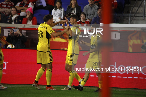 Columbus FC's Yevhen Cheberko (21) celebrates the winning goal with teammates during the MLS League match between Columbus FC and New York R...