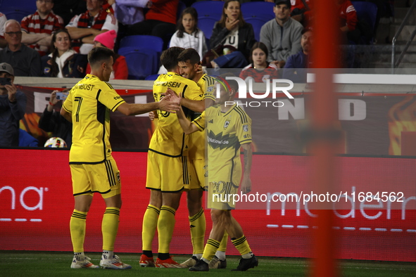 Columbus FC's Yevhen Cheberko (21) celebrates the winning goal with teammates during the MLS League match between Columbus FC and New York R...