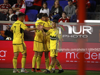 Columbus FC's Yevhen Cheberko (21) celebrates the winning goal with teammates during the MLS League match between Columbus FC and New York R...