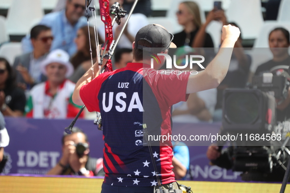 James Lutz of the United States competes against Mathias Fullerton of Denmark (not in picture) during the men's compound gold medal match on...