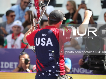 James Lutz of the United States competes against Mathias Fullerton of Denmark (not in picture) during the men's compound gold medal match on...