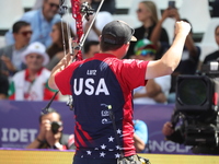 James Lutz of the United States competes against Mathias Fullerton of Denmark (not in picture) during the men's compound gold medal match on...