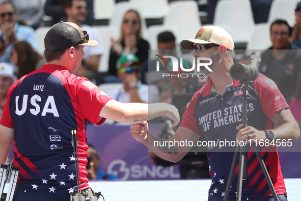 James Lutz of the United States competes against Mathias Fullerton of Denmark (not in picture) during the men's compound gold medal match on...