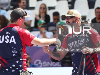 James Lutz of the United States competes against Mathias Fullerton of Denmark (not in picture) during the men's compound gold medal match on...