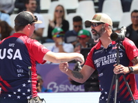 James Lutz of the United States competes against Mathias Fullerton of Denmark (not in picture) during the men's compound gold medal match on...