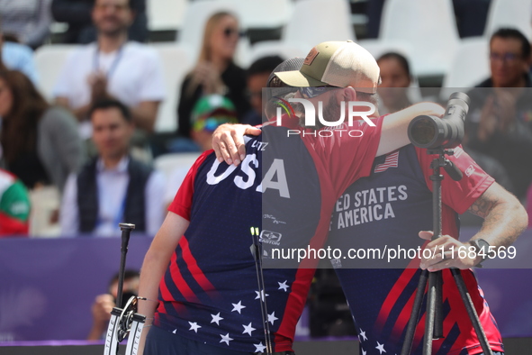 James Lutz of the United States competes against Mathias Fullerton of Denmark (not in picture) during the men's compound gold medal match on...